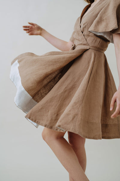 Woman wearing Son de Flor hemp wrap dress with short sleeve in beige color